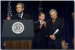 President George W. Bush announces the new director of the National Cancer Institute Dr. Andrew von Eschenbach (right) as Secretary of Health and Human Services Tommy Thompson applauds. White House photo by Moreen Ishikawa.