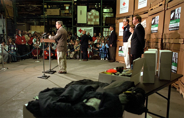 "There have been bake sales and there have been lemonade stands; and there are empty piggy banks and there have been all kinds of drives to raise money for the Afghan children," said President George W. Bush at the Church of the Brethren Warehouse New Windsor, Maryland Dec. 8. Children from across the country donated their efforts and dollars to buy clothing, toys, school and other supplies. White House photo by Paul Morse.