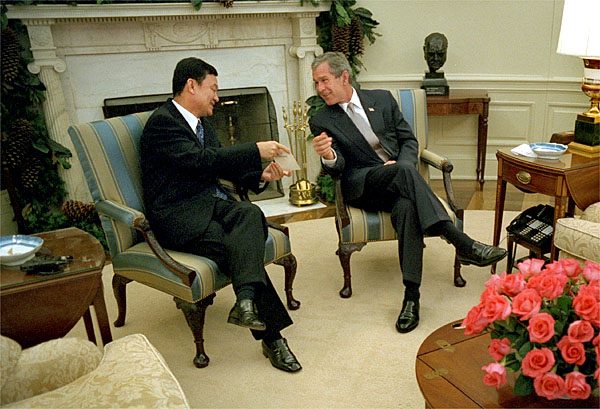 President George W. Bush meets with Prime Minister Thaksin Shinawatra of Thailand in the Oval Office Dec. 14, 2001. The two leaders discusses economic issues and the war on terrorism. White House photo by Eric Draper.