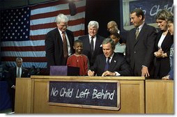 Visiting Hamilton High School in Hamilton, Ohio, Jan. 8, President George W. Bush signs into law historic, bi-partisan education legislation. On hand for the signing are Democratic Rep. George Miller of California (far left), Democratic U.S. Sen. Edward Kennedy of Massachusetts (center, left), Secretary of Education Rod Paige (center, behind President Bush), Republican Rep. John Boehner of Ohio, and Republican Sen. Judd Gregg of New Hampshire (not pictured).  White House photo by Paul Morse