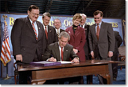 President George W. Bush signs the Small Business Liability Relief and Brownfields Revitalization Act in Conshohocken, Pennsylvania, Jan. 11. Standing left to right and Rep. Paul Gillmor of Ohio, Rep. Robert Borski of Penn., State Attorney General Mike Fisher, EPA Administrator Christie Todd Whitman, Rep. Joseph Hoeffel of Penn. and Pennsylvania Governor Mark Schweiker. White House photo by Eric Draper.