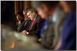 President George W. Bush, Mrs. Bush and Sen. Jon Kyl of Arizona pray during the National Prayer Breakfast at the Washington Hilton Hotel Feb. 7. 