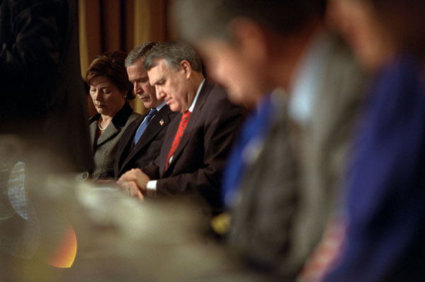 President George W. Bush, Mrs. Bush and Sen. Jon Kyl of Arizona pray during the National Prayer Breakfast at the Washington Hilton Hotel Feb. 7. "Since we met last year, millions of Americans have been led to prayer," said the President. "They have prayed for comfort in time of grief; for understanding in a time of anger; for protection in a time of uncertainty." White House photo by Tina Hager.