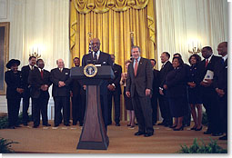 President George W. Bush listens as Secretary of Education Rod Paige speaks to visiting leaders from historically black colleges in the East Room, Feb. 12, 2002. Pledging to help historically black colleges, President Bush has created a presidential advisory board that will report on the schools' academic performances, uses of technology, and development. White House photo by Eric Draper.