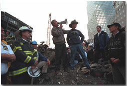 Standing upon the ashes of the worst terrorist attack an American soil, President George W. Bush pledges that the voices from across America calling for justice will be heard during a trip to Ground Zero in New York Sept. 14. White House photo by Eric Draper.