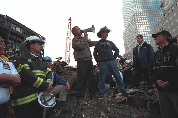 Standing upon the ashes of the worst terrorist attack an American soil, President George W. Bush pledges that the voices from across America calling for justice will be heard during a trip to Ground Zero in New York Sept. 14. White House photo by Eric Draper.