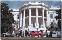 President George W. Bush inspects fuel-efficient cars on the South Lawn of the White House Feb. 25. "Technologies will also enable us to preserve our environment as we explore for natural gas at home," said the President in his remarks as Secretary of Energy Spence Abraham and Administrator Christine Todd Whitman of the Environmental Protection Agency stood by his side. White House photo by Paul Morse.