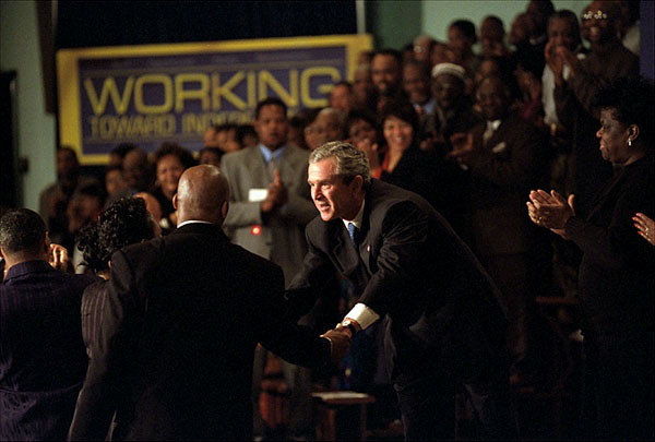 President George W. Bush meets with audience members during his remarks at St. Luke's Catholic Church in Washington, D.C., Feb. 26. "I believe Americans in need are not problems; they are our neighbors. They're not strangers; they are citizens of our country. And to live up to our national ideals, ideals of equality and justice, every American of every background must have access to opportunity," said the President as he explained the details of his welfare reforms. "In times of personal crisis, people do not need the rules of a bureaucracy; they need the help of a neighbor." White House photo by Eric Draper.