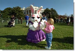 An early visitor gets in a game of patty-cake with the Easter Bunny during the Annual Easter Egg Roll on the South Lawn of the White House Monday, April 1. In addition to meeting such notables as the Easter Bunny, children played games, listened to story book readings and had their pictures taken all over the place. White House photo by Tina Hager.