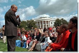 Secretary of Education Roderick Paige reads to children during on of the many story book hours at the Annual Easter Egg Roll on the South Lawn of the White House April 1. Other readers including Laura Bush, Secretary of Transportation Norm Mineta and Marc Brown, children's book author of Arthur Meets the President. White House photo by Evan Parker.