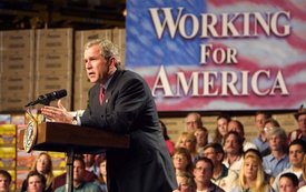 President George W. Bush addresses folks at a General Mills plant in Cedar Rapids, Iowa, Monday, April 15. Taking to the podium on tax day, the President discussed last year's tax cut that and stated that such cuts for the American people should be permanent.  White House photo by Paul Morse