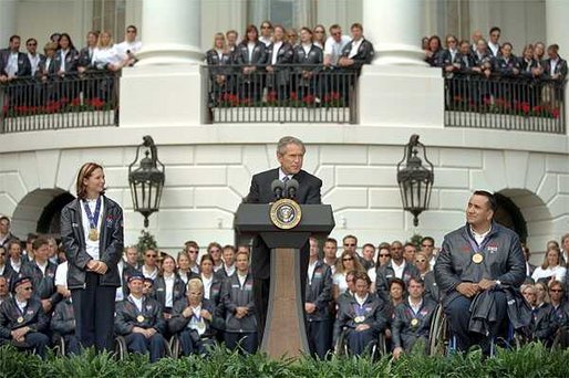 President George W. Bush addresses visiting athletes during a ceremony honoring the efforts of the U.S. Olympic and Paralympic teams on the South Lawn Tuesday, April 23. Pictured on stage with the President is gold medalists Tristan Gale, left, and Manuel Guerra. "It is a great honor to host our nation's Olympic and Paralympic athletes here at the White House," said the President "You competed with honor, you won with humility and you made America proud." White House photo by Tina Hager.