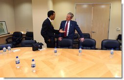 President George W. Bush listens as John Bryant, Founder, Chairman and CEO of Operation HOPE talks following a roundtable with community leaders at First African Methodist Episcopal Renaissance Center in Los Angeles, Ca., Monday, April 29, 2002. Eric Draper.