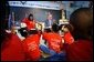 President George W. Bush visits with teacher Carolyn Davis and her students at Clarke Street Elementary School in Milwaukee, Wis., Wednesday, May 8. "I'm here because this is a great school that believes every child can learn," said President Bush who listened to the students demonstrate their reading drills. During his talk with the children, the President emphasized the importance of reading over watching television. 