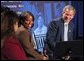 President George W. Bush laughs with participants during a conversation on welfare reform at The Church at Rock Creek in Little Rock, Arkansas on June 3, 2002. White House photo by Eric Draper.