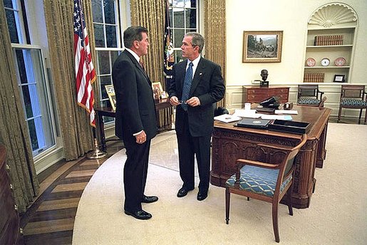 President George W. Bush meets with his new Director of Homeland Security Tom Ridge in the Oval Office shortly before swearing Mr. Ridge in for the position at a White House ceremony Monday, Oct. 8. White House photo by Eric Draper.