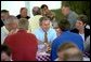 President George W. Bush sits down with families at a barbecue picnic at the 14th Annual World Pork Expo in Des Moines, Iowa. The President’s Job and Growth Plan helps American families by increasing the standard deduction for married couples, raising the Child Tax Credit and eliminating the double taxation of dividends earned by stockholders White House photo by Eric Draper