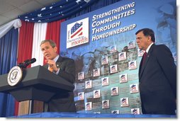 As Secretary Mel Martinez listens, President George W. Bush discusses home ownership at the Department of Housing and Urban Development Tuesday, June 18. "We want 5.5 million more homeowners by 2010 -- million more minority homeowners by 2010," said the President. "Five-and-a-half million families by 2010 will own a home. That is our goal. It is a realistic goal." White House photo by Tina Hager.