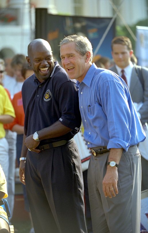 President George W. Bush takes in the excitement of the White House Fitness Expo on the South Lawn with Dallas Cowboys Running Back Emmitt Smith June 20. 