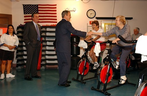 Accompanied by the Governor of Florida, his brother Jeb Bush, President George W. Bush visits senior citizens participating in an aerobic "spinning class" at the Marks street Senior Recreation Complex in Orlando, Fla., Friday, June 21, 2002. White House photo by Tina Hager.