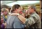 President George W. Bush greets familes displaced by the Arizona forest fires at Round Valley High School in Eagar, Ariz., Tuesday, June 25. White House photo by Eric Draper.