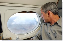 President George W. Bush looks out the window of Air Force One during an aerial tour of the forest fires over Springerville, Ariz., Tuesday, June 25. White House photo by Eric Draper.