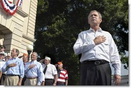 President George W. Bush joins war veterans on stage during the Pledge of Allegniance to open the 