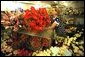 White House Florist Wendy Elsasser prepares an arrangement of red Gerbera Daises as one of the many bouquests to be used at the State Dinner for Polish President Alexander Kwasniewski tonight, July 17. White House photo by Tina Hager