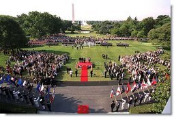 President George W. Bush and Laura Bush stand with visiting President Alexander Kwasniewski of Poland and his wife, Jolanta Kwasniewska, during the State Arrival Ceremony on the South Lawn Wednesday, July 17. White House photo by Paul Morse.