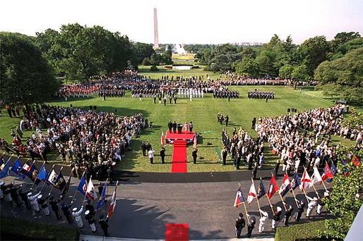 President George W. Bush and Laura Bush stand with visiting President Aleksander Kwasniewski of Poland and his wife, Jolanta Kwasniewska, during the State Arrival Ceremony on the South Lawn Wednesday, July 17. White House photo by Paul Morse.