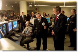 President George W. Bush listens to Hermann Grunder, Director of the Argonne National Laboratory, during a tour of the research facilities with Homeland Security Director Tom Ridge, Secretary of Energy Spencer Abraham and Speaker of the House of Representatives Dennis Hastert, R-IL., in Argonne, IL., July 22. Sponsored by the Dept. of Energy and operated by the University of Chicago, the laboratory is combating terrorism through innovative projects such as detectors for neutrons, biological and chemical agents and developing an emergency response system that coordinates various technologies. White House photo by Paul Morse.