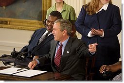 President George W. Bush reacts to the audience during the signing of the proclamation that marks the 12th Anniversary of the Americans with Disabilities Act in the East Room Friday, July 26. White House photo by Paul Morse.