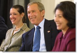 President George W. Bush listens to a suggestion with panelists Carmen Agiuar, left, and Delia Garcia at the Corporate Responsibility discussion panel at the President's Economic Forum held at Baylor University in Waco, Texas on Tuesday August 13, 2002. White House photo by Paul Morse.