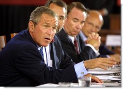 President George W. Bush talks to panelists during a drop-by of the discussion panel on Healthcare Security at the President's Economic Forum held at Baylor University in Waco, Texas on Tuesday August 13, 2002. White House photo by Paul Morse.