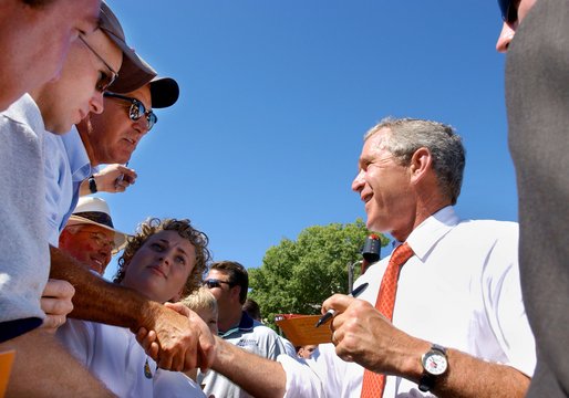 President George W. Bush greets the audience after speaking at the Iowa State Fair Fairgrounds, Wednesday, Aug. 14, 2002. 