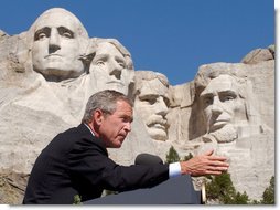 President George W. Bush discusses the security of America at Mount Rushmore in South Dakota Thursday, Aug. 15 "More and more people understand that being a patriot is more than just putting your hand over your heart and saying the Pledge of Allegiance to a nation under God. (Applause.) They're saying -- more and more people understand that serving something greater than yourself in life is a part of being a complete American," said the President in his remarks. White House photo by Eric Draper.