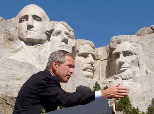 President George W. Bush discusses the security of America at Mount Rushmore in South Dakota Thursday, Aug. 15 "More and more people understand that being a patriot is more than just putting your hand over your heart and saying the Pledge of Allegiance to a nation under God. (Applause.) They're saying -- more and more people understand that serving something greater than yourself in life is a part of being a complete American," said the President in his remarks. 