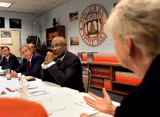 President George W. Bush, left, listens to Principal Dr. Linda G. Brown speak during a round table on education at Parkview Arts and Science Magnet High School in Little Rock, Arkansas, Thursday, Aug. 29. Also pictured are Education Secretary Rod Paige, right and Sen. Tim Hutchinson. White House photo by Eric Draper.