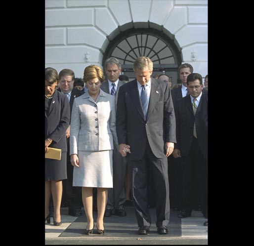 President George W. Bush and Laura Bush join the White House staff in bowing their heads in a moment of silence on the South Lawn of the White House 8:46 a.m. Wednesday, Sept 11. The President observed this moment to mark the one-year anniversary of when United Airlines Flight 175 crashed into the South Tower of the World Trade Center. White House photo by Eric Draper.