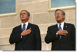 Attending the Pentagon Observance ceremony, President George W. Bush and Secretary of Defense Donald Rumsfeld say the Pledge of Allegiance before speaking Tuesday, Sept. 11. White House photo by Eric Draper.