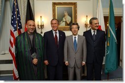 President George W. Bush poses for a group photo with, from left, President of Afghanistan Hamid Karzai, Japanese Prime Minister Junichiro Koizumi and Saudi Arabian Foreign Minister Prince Saud al-Faisal at the Waldorf-Astoria Hotel in New York City, Thursday, Sept. 12, 2002. The leaders announced a joint project to provide $180 million for road improvements in Afghanistan. White House photo by Eric Draper.