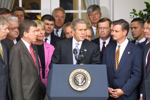 Standing with members of Congress, President George W. Bush discusses America's position on Iraq in the Rose Garden Thursday, Sept. 26. "We are moving toward a strong resolution. And all of us, and many others in Congress, are united in our determination to confront an urgent threat to America," explained the President. "And by passing this resolution we'll send a clear message to the world and to the Iraqi regime: the demands of the U.N. Security Council must be followed." White House photo by Paul Morse.