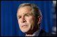 As the flag at the White House is flown at half-staff, President George W. Bush expresses condolences in his opening remarks during his and President Jiang Zemin's joint press conference in Crawford, Texas, Oct. 25. "Our prayers and heart-felt sympathy goes to their sons, their loved ones, their friends, and the people of Minnesota," said the President. White House photo by Tina Hager.