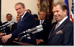 President George W. Bush listens to an interpreter during a joint press conference with Czech Republic President Vaclav Havel at Prague Castle in Prague, Czech Republic, Wednesday Nov. 20.   White House photo by Paul Morse