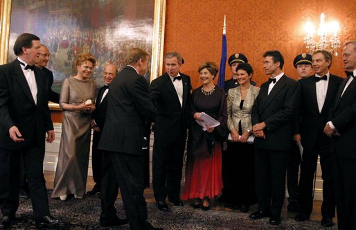 President George W. Bush and Mrs. Bush congratulate Czech Republic President Vaclav Havel during a gift presentation before a dinner for NATO leaders at Prague Castle in Prague, Czech Republic, Nov. 20. White House photo by Paul Morse