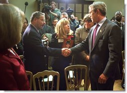 President George W. Bush talks with some of family members of those who were killed during the September 11 attacks after signing Intelligence Authorization Act in the Roosevelt Room, Wednesday, Nov. 27. The act of Congress will authorize intelligence programs and creating a national commission to investigate the events of September 11, 2001.  White House photo by Paul Morse