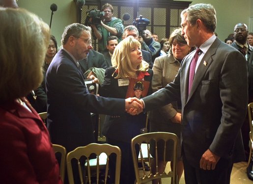 President George W. Bush talks with some of family members of those who were killed during the September 11 attacks after signing Intelligence Authorization Act in the Roosevelt Room, Wednesday, Nov. 27. The act of Congress will authorize intelligence programs and creating a national commission to investigate the events of September 11, 2001. White House photo by Paul Morse