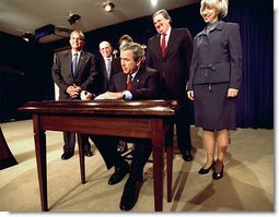 President George W. Bush signs H.R. 3908, the Reauthorization of the North American Wetlands Conservation Act in the Dwight D. Eisenhower Executive Office Building Dec. 2. Standing with the President for the signing are, from left to right, Rep. Robert Underwood (D-Guam), Rep. Wayne Gilchrest (R-MD), Sec. of Agriculture Ann Veneman, Sen. Bon Smith (R-NH) and Sec of Interior Gale Norton. The legislation matches federal funds with non-federal sources to promote public-private partnerships that conserve and restore the nation's wetlands.  White House photo by Tina Hager