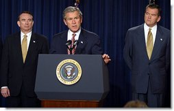 President George W. Bush discusses his smallpox vaccination program during a press conference as Secretary of Health & Human Services Tommy Thompson, left, and Director of the Office of Homeland Security Tom Ridge in the Dwight D. Eisenhower Executive Office Building Friday, Dec. 13.   White House photo by Paul Morse