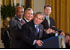 President George W. Bush acknowledges school principals and superintendents, education leaders, and Members of Congress in celebrating the one-year anniversary of the signing of the No Child Left Behind Act in the East Room, Wednesday, Jan. 8, 2003.  White House photo by Tina Hager